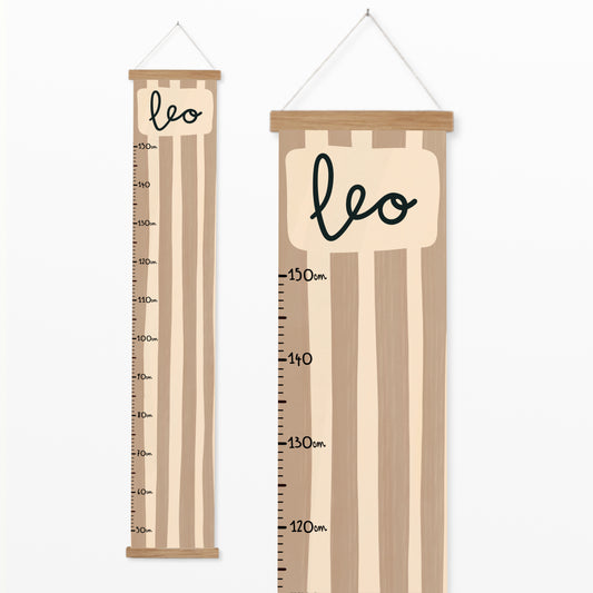 Personalised canvas height chart featuring hand-painted blush and taupe stripes with a name at the top and measurement markings from 50 cm to 150 cm.