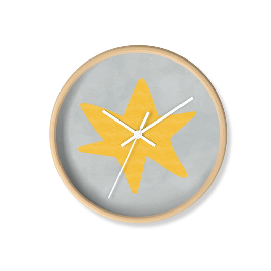 Round bamboo wall clock with hand-painted yellow star on a grey-blue background and white clock hands, perfect for nursery or playroom decor