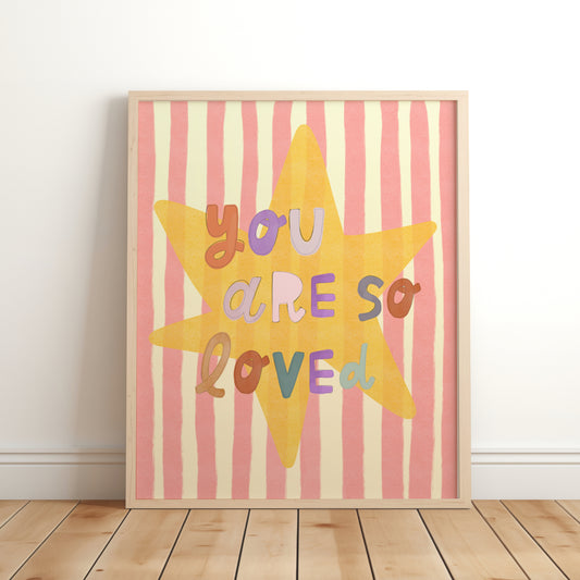 Playful kids’ wall art print with the phrase ‘You Are So Loved’ in multicoloured letters on a large yellow star with pink and cream stripes in the background – framed nursery print